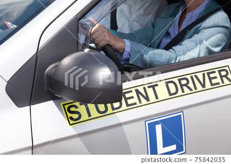 Learning to drive a car with a driving instructor. Student driver. 75842035