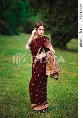 Beautiful Arabian woman portrait. Young Hindu woman with mehndi tattoos from black henna on her Beautiful Arabian woman portrait. Young Hindu woman with mehndi tattoos from black henna on her 75842822