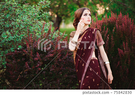 Portrait of beautiful indian girl. Young hindu woman model with tatoo mehndi and kundan jewelry Portrait of beautiful indian girl. Young hindu woman model with tatoo mehndi and kundan jewelry 75842830