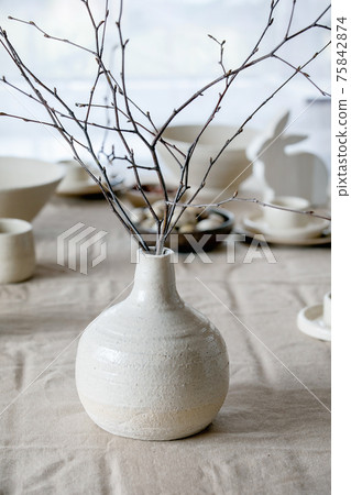Spring birch branches in white ceramic vase 75842874