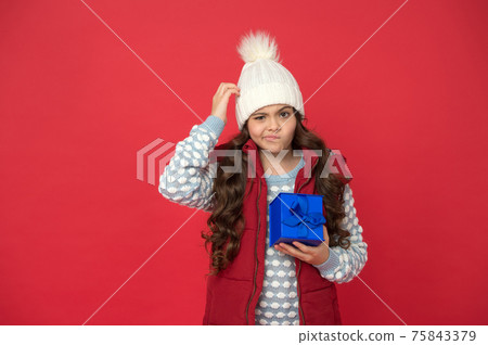 Online shopping. thoughtful kid in winter outfit red background. ys. make pleasant things Online shopping. thoughtful kid in winter outfit red background. ys. make pleasant things 75843379