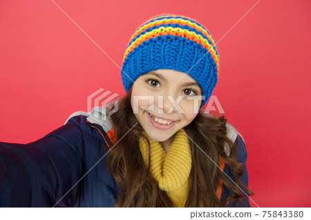 Selfie camera. Smiling cute face. Little girl wear winter Selfie camera. Smiling cute face. Little girl wear winter 75843380