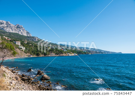View of the sea and cliffs. Tourism in the Crimea. Summer photo of a sea landscape. View of the sea and cliffs. Tourism in the Crimea. Summer photo of a sea landscape. 75843447