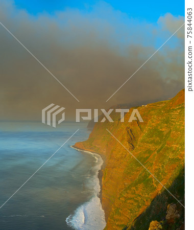 Smoke burning forest ocean Madeira 75844063