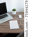 Office at home. LaptOffice at home. Laptop. notebook. pen are on the table.op. notebook. pen are on the table. 75844279