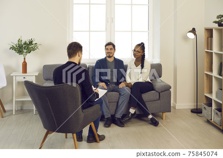 Pleased mixed race couple meeting family psychiatrist or financial advisor Pleased mixed race couple meeting family psychiatrist or financial advisor 75845074
