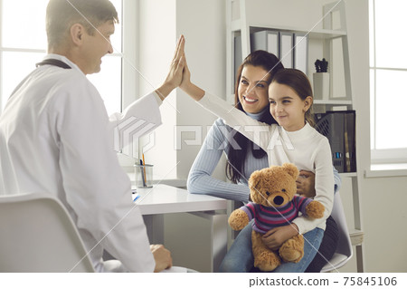 Happy little girl patient gives five smiling male pediatrician after medical examination. 75845106