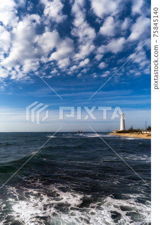 Lone beacon guards the ships. The lighthouse shows the way for boats. Wrecked ship lays nearby Lone beacon guards the ships. The lighthouse shows the way for boats. Wrecked ship lays nearby 75845140