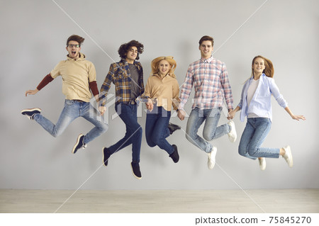 Full-length portrait of enthusiastic caucasian european teenager jumping high 75845270