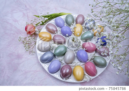 Easter decoration with colored eggs, tulip and gypsophila close-up on a light background. Easter decoration with colored eggs, tulip and gypsophila close-up on a light background. 75845786