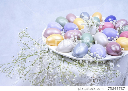 Easter decoration with colored eggs, and gypsophila close-up on a light background. Easter decoration with colored eggs, and gypsophila close-up on a light background. 75845787