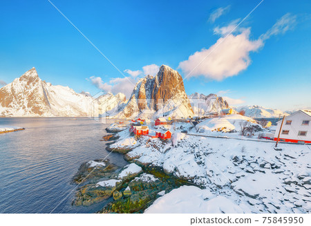 Astonishing winter view on Hamnoy village and Festhaeltinden mountain on background. Astonishing winter view on Hamnoy village and Festhaeltinden mountain on background. 75845950