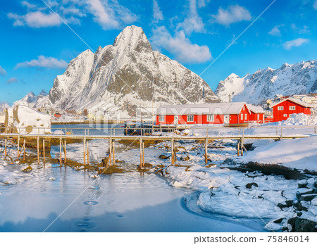 Fabulous winter sunny view on Reine Village and footbridge above Gravdalbukta bay with cracked ice Fabulous winter sunny view on Reine Village and footbridge above Gravdalbukta bay with cracked ice 75846014