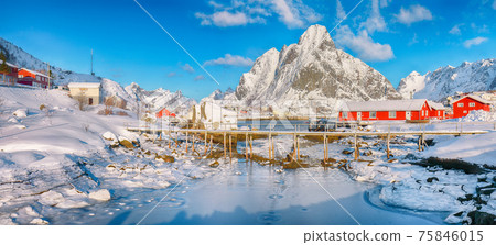 Fabulous winter sunny view on Reine Village and footbridge above Gravdalbukta bay with cracked ice Fabulous winter sunny view on Reine Village and footbridge above Gravdalbukta bay with cracked ice 75846015