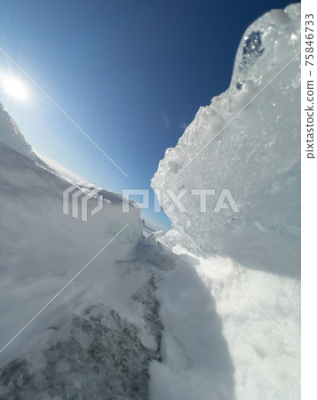 Ice slopes in sunny winter day, transparent ice of blue color, purely blue sky, long shadows, a pure snow-covered virgin soil, snow barkhans, Ice slopes in sunny winter day, transparent ice of blue color, purely blue sky, long shadows, a pure snow-covered virgin soil, snow barkhans, 75846733