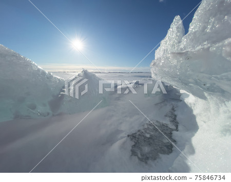Ice slopes in sunny winter day, transparent ice of blue color, purely blue sky, long shadows, a pure snow-covered virgin soil, snow barkhans, Ice slopes in sunny winter day, transparent ice of blue color, purely blue sky, long shadows, a pure snow-covered virgin soil, snow barkhans, 75846734