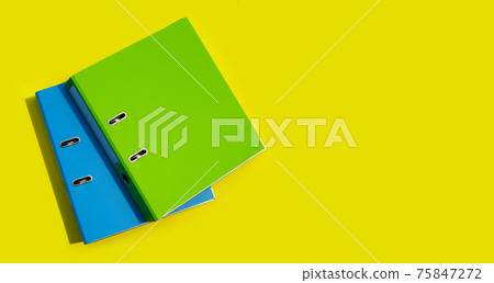 Office folders on yellow background. Office folders on yellow background. 75847272