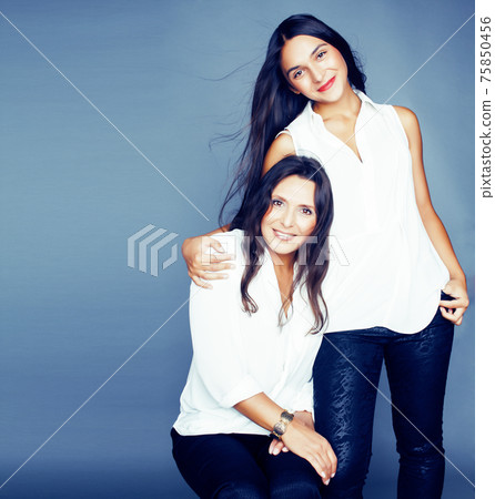cute pretty teen daughter with mature mother hugging, fashion style brunette, lifestyle people concept cute pretty teen daughter with mature mother hugging, fashion style brunette, lifestyle people concept 75850456