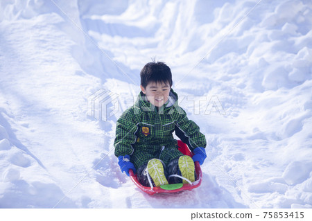 Children playing sledding Children playing sledding 75853415