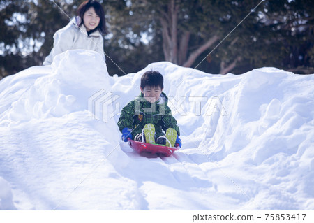 Children playing sledding Children playing sledding 75853417