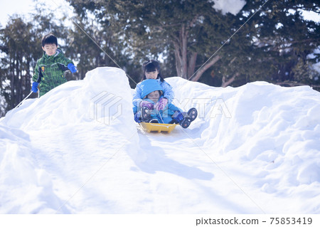 Children playing sledding Children playing sledding 75853419