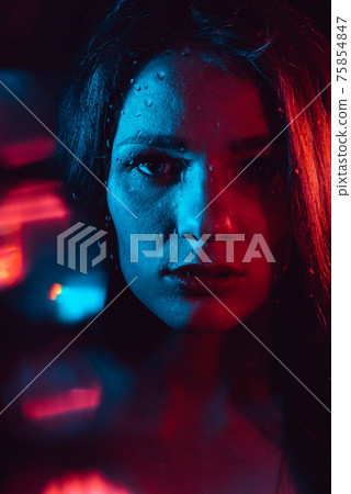 Sensual portrait of a beautiful attractive girl looking through the glass with raindrops Sensual portrait of a beautiful attractive girl looking through the glass with raindrops 75854847