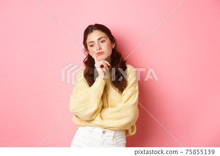 Thoughtful sad girl looking aside, spacing out, thinking what to do, standing moody and upset against pink background Thoughtful sad girl looking aside, spacing out, thinking what to do, standing moody and upset against pink background 75855139