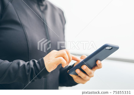 Asian woman using smartphone outdoors Asian woman using smartphone outdoors 75855331