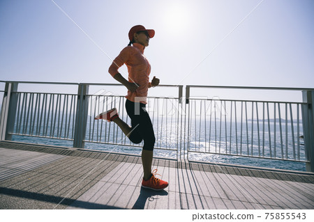 Healthy lifestyle fitness sports woman runner running on seaside trail 75855543