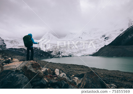 Woman hiker in winter high altitude mountains Woman hiker in winter high altitude mountains 75855569