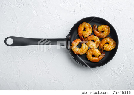 Grilled shrimps, on frying iron pan, on white background, top view flat lay , with copyspace and space for text 75856316