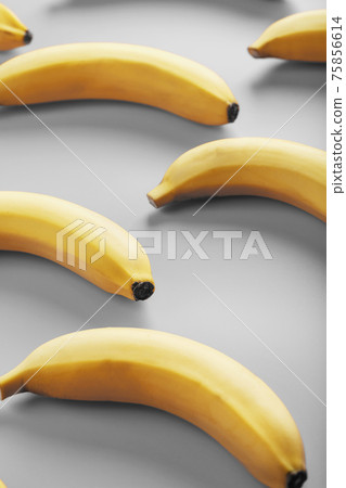 Geometric pattern of yellow bananas on a gray background in the Fashionable colors of 2021. 75856614