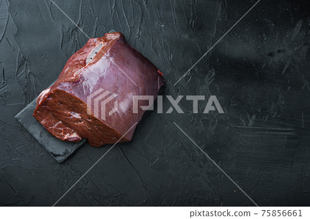 Raw beef liver on black background, flat lay with copy space Raw beef liver on black background, flat lay with copy space 75856661