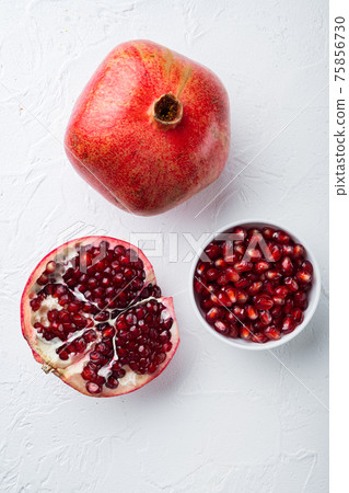Ripe pomegranate with fresh juicy seeds, on white textured background, flat lay Ripe pomegranate with fresh juicy seeds, on white textured background, flat lay 75856730