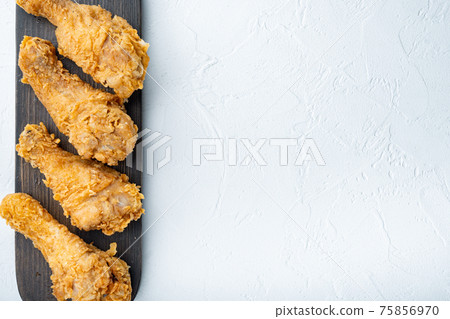 Breaded kentucky chicken drumctick on white background, flat lay, with space for text 75856970