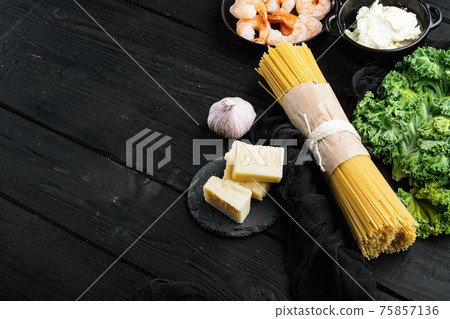 Ingredients for pasta Spaghetti with seafood. Shrimps, prawns,cheese, on black wooden table background , with copyspace and space for text Ingredients for pasta Spaghetti with seafood. Shrimps, prawns,cheese, on black wooden table background , with copyspace and space for text 75857136