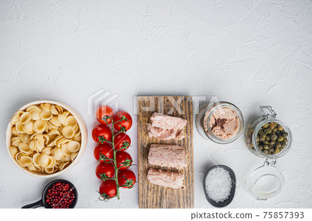 Tuna salad with pasta and vegetables ingredients, on white background, top view with copy space for text 75857393