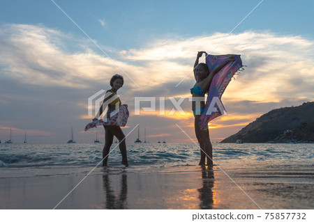 Two women posing beautiful on the beach. 75857732