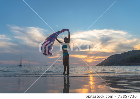 A woman poses with a beautiful sarong. 75857736