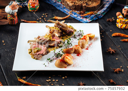 Roatsed lamb rib cutlets with baby potatoes Roatsed lamb rib cutlets with baby potatoes 75857932