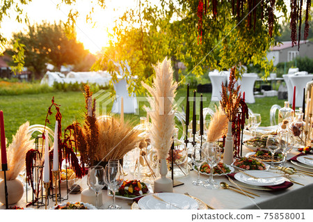 Banquet table with variety of oriental appetizers 75858001