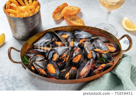 Mussels dinner with wine, fries, and toasted bread Mussels dinner with wine, fries, and toasted bread 75859451
