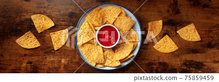 Nachos panorama with a tomato salsa, top shot 75859459