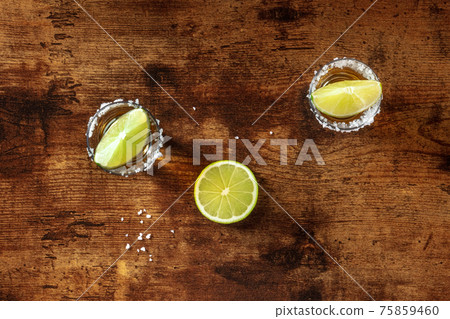 Tequila with salt and lime, overhead shot on a wooden background 75859460
