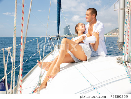 Couple enjoying sea trip along coast of Barcelona Couple enjoying sea trip along coast of Barcelona 75860269