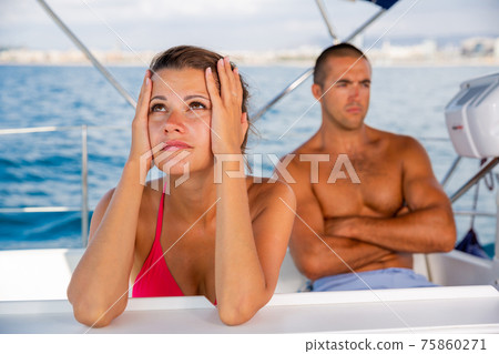 Frustrated woman with husband at sailboat 75860271