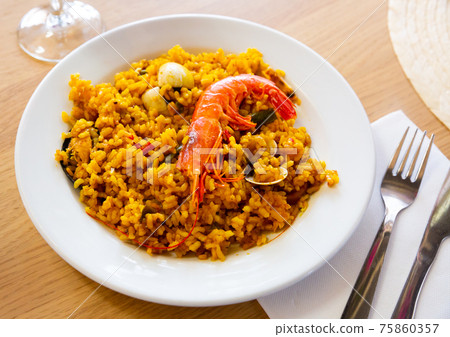 Spainsh dish seafood paella with rice, shrimps and mussels Spainsh dish seafood paella with rice, shrimps and mussels 75860357