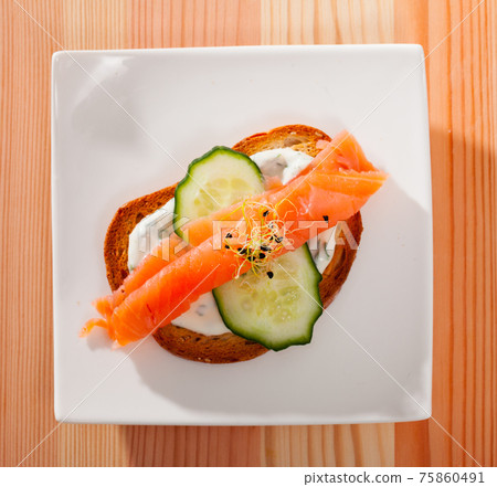 Sandwich with salmon, cucumber, sauce Sandwich with salmon, cucumber, sauce 75860491
