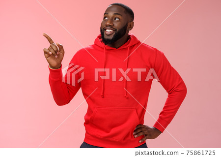 Happy charismatic delighted african-american bearded guy smiling white teeth look pointing intrigued upper left corner curious what interesting product standing impressed pink background 75861725