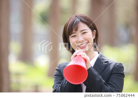 A woman holding a megaphone and cheering 75862444
